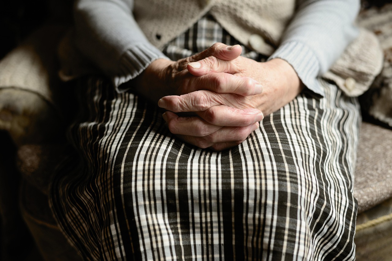 Gentle hands providing compassionate care support, representing the specialized memory care services available in Orange County for seniors with Alzheimer's and dementia